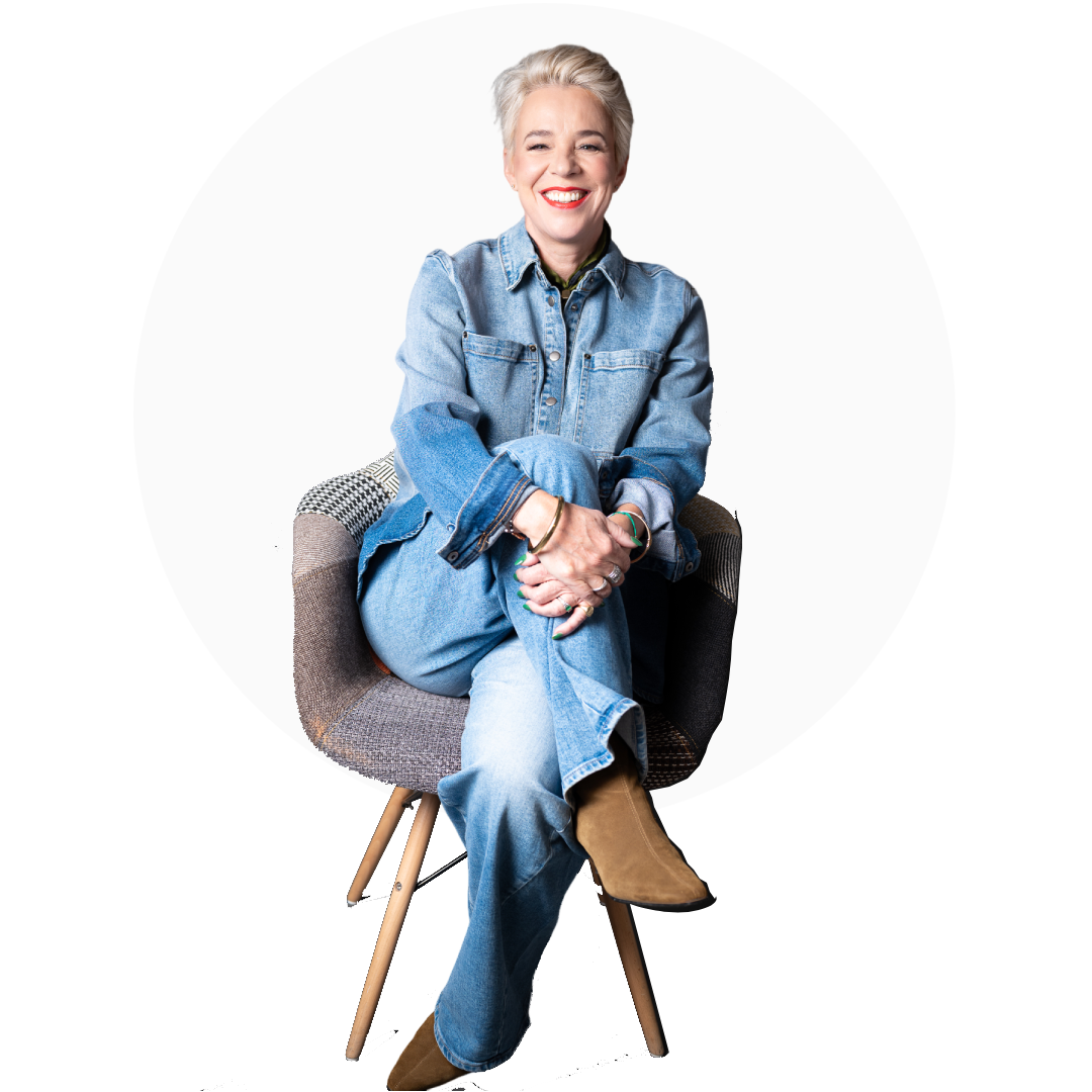Smiling elderly woman sitting comfortably on a modern chair.